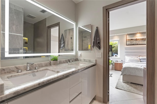 full bath featuring tile patterned floors, a sink, double vanity, and ensuite bath