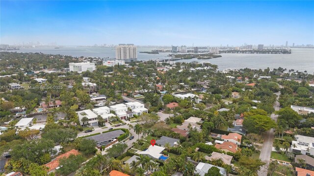 birds eye view of property featuring a city view and a water view