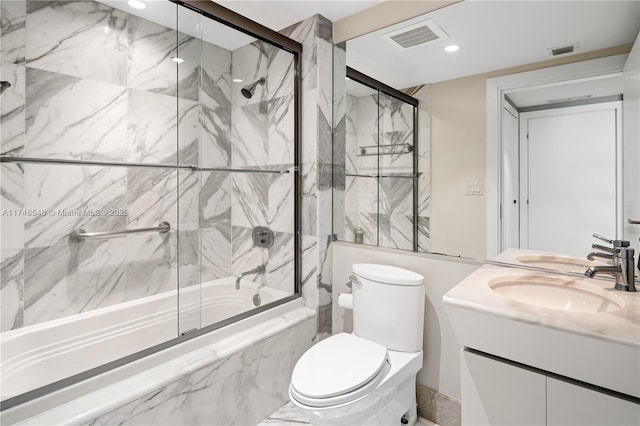 full bathroom featuring visible vents, toilet, vanity, and shower / bath combination with glass door