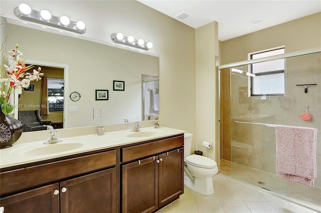 ensuite bathroom with tile patterned flooring, toilet, visible vents, and a sink