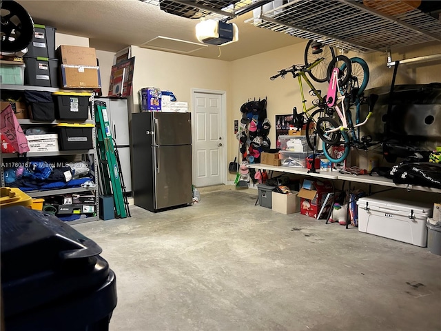 garage featuring a garage door opener and freestanding refrigerator