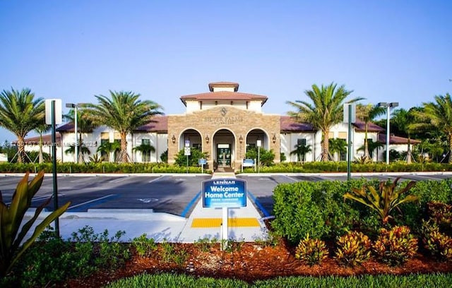 view of building exterior featuring uncovered parking