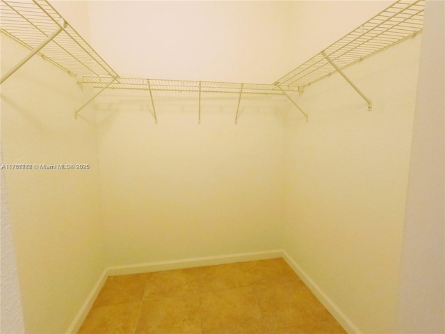 walk in closet featuring light tile patterned floors