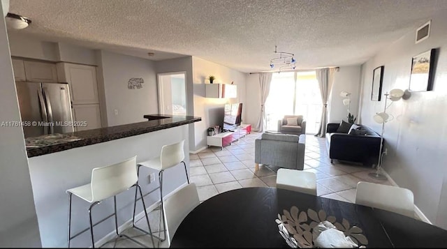 19555 E Country Club Dr Unit 8507, Aventura, FL 33180 - dining area featuring light tile patterned flooring, baseboards, visible vents, and a textured ceiling
