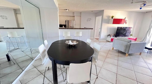 19555 E Country Club Dr Unit 8507, Aventura, FL 33180 - dining space featuring light tile patterned floors, a textured ceiling, and baseboards