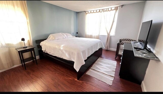 19555 E Country Club Dr Unit 8507, Aventura, FL 33180 - bedroom with baseboards and wood finished floors