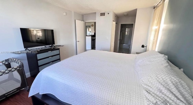 19555 E Country Club Dr Unit 8507, Aventura, FL 33180 - bedroom featuring a closet, visible vents, a textured ceiling, and wood finished floors