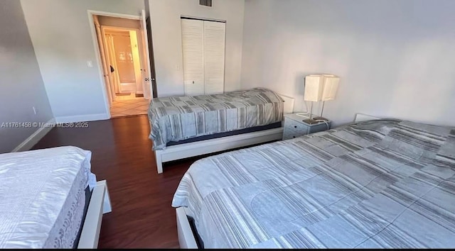 19555 E Country Club Dr Unit 8507, Aventura, FL 33180 - bedroom featuring a closet, visible vents, baseboards, and wood finished floors