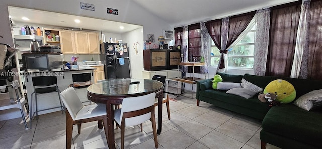 dining space with light tile patterned floors, visible vents, recessed lighting, and vaulted ceiling