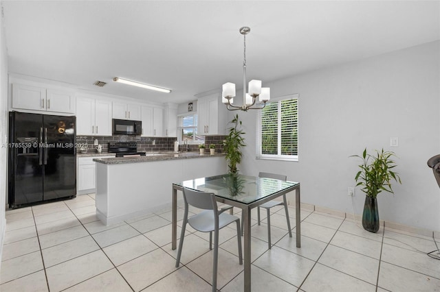 dining area featuring light tile patterned flooring, visible vents, and an inviting chandelier