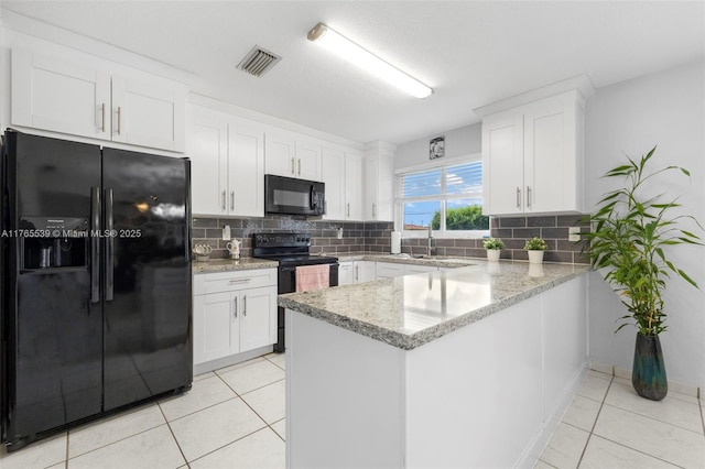 kitchen with black appliances, tasteful backsplash, white cabinets, and a peninsula