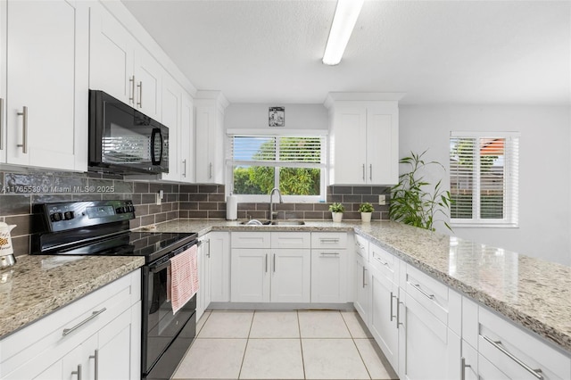 kitchen featuring white cabinetry, a sink, black appliances, backsplash, and light tile patterned floors