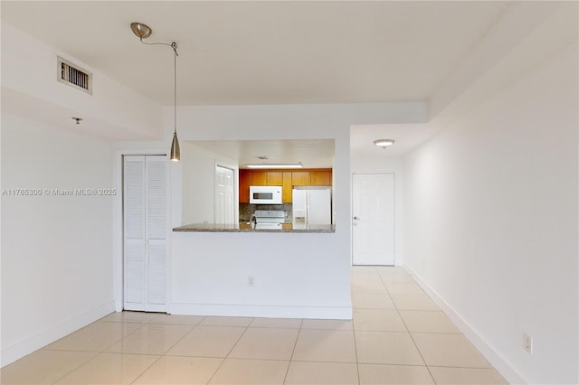 1650 Coral Way Unit Ph-9, Miami, FL 33145 - kitchen with white appliances, tasteful backsplash, baseboards, light tile patterned flooring, and pendant lighting