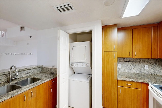 1650 Coral Way Unit Ph-9, Miami, FL 33145 - laundry area featuring stacked washer / drying machine