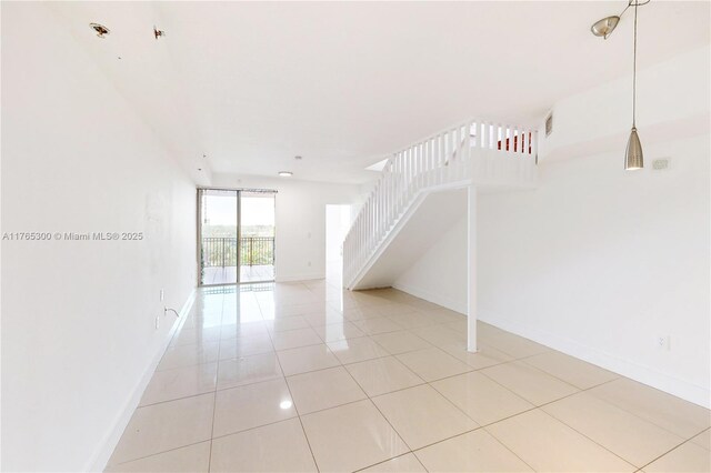 1650 Coral Way Unit Ph-9, Miami, FL 33145 - spare room featuring stairs, baseboards, and light tile patterned floors