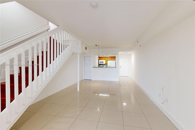 1650 Coral Way Unit Ph-9, Miami, FL 33145 - unfurnished living room with light tile patterned flooring, stairs, and baseboards