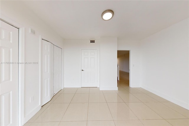 1650 Coral Way Unit Ph-9, Miami, FL 33145 - unfurnished bedroom with light tile patterned floors, baseboards, and a closet