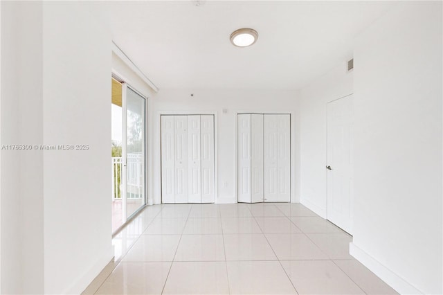 1650 Coral Way Unit Ph-9, Miami, FL 33145 - hallway featuring baseboards and light tile patterned floors
