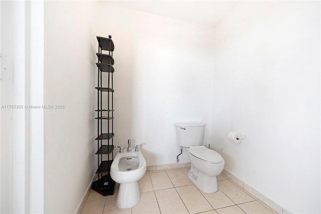 1650 Coral Way Unit Ph-9, Miami, FL 33145 - bathroom with a bidet, toilet, tile patterned flooring, and baseboards