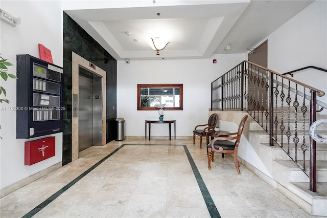 1650 Coral Way Unit Ph-9, Miami, FL 33145 - hallway with elevator, inlaid floor details, stairway, a tray ceiling, and baseboards