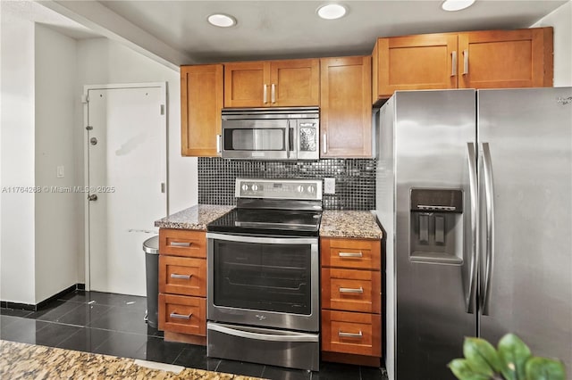 4400 Hillcrest Dr Unit 720C, Hollywood, FL 33021 - kitchen featuring stainless steel appliances, decorative backsplash, light stone counters, brown cabinets, and recessed lighting