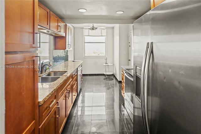 4400 Hillcrest Dr Unit 720C, Hollywood, FL 33021 - kitchen with appliances with stainless steel finishes, brown cabinets, light stone counters, recessed lighting, and ceiling fan