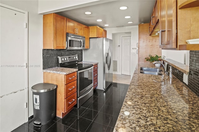 4400 Hillcrest Dr Unit 720C, Hollywood, FL 33021 - kitchen with stainless steel appliances, recessed lighting, tasteful backsplash, light stone counters, and brown cabinetry