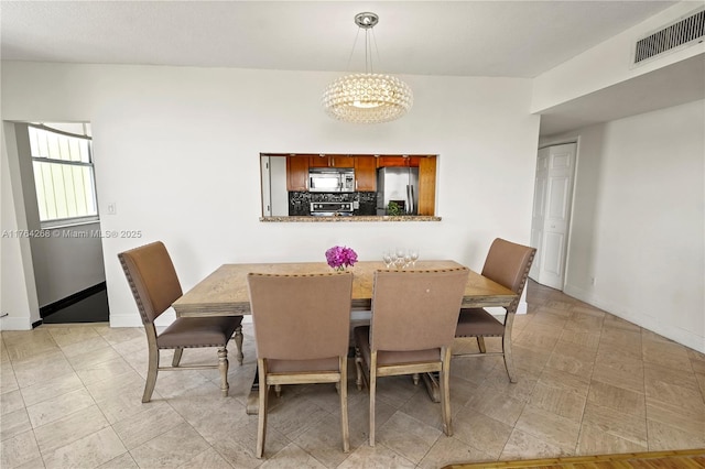 4400 Hillcrest Dr Unit 720C, Hollywood, FL 33021 - dining space featuring a chandelier and baseboards