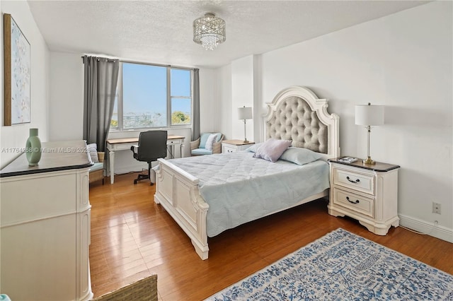 4400 Hillcrest Dr Unit 720C, Hollywood, FL 33021 - bedroom with dark wood-style floors, a chandelier, a desk, and a textured ceiling