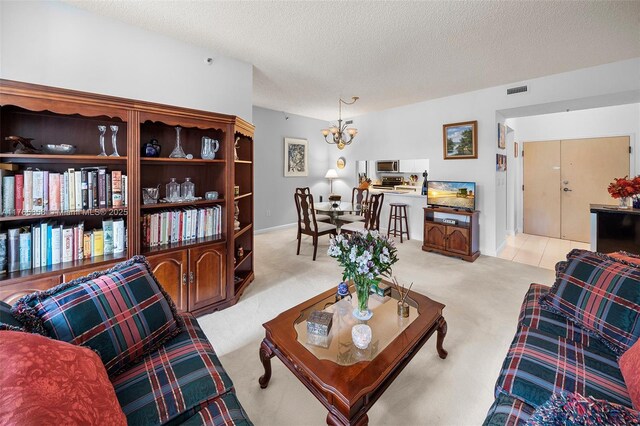 9805 NW 52nd St Unit 215, Doral, FL 33178 - living area featuring an inviting chandelier, light colored carpet, visible vents, and a textured ceiling