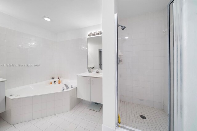 9805 NW 52nd St Unit 215, Doral, FL 33178 - bathroom with a bath, tile patterned floors, a stall shower, and vanity