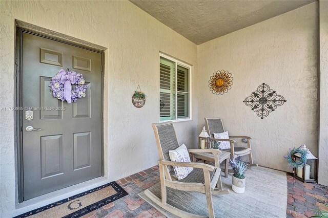 view of exterior entry featuring stucco siding