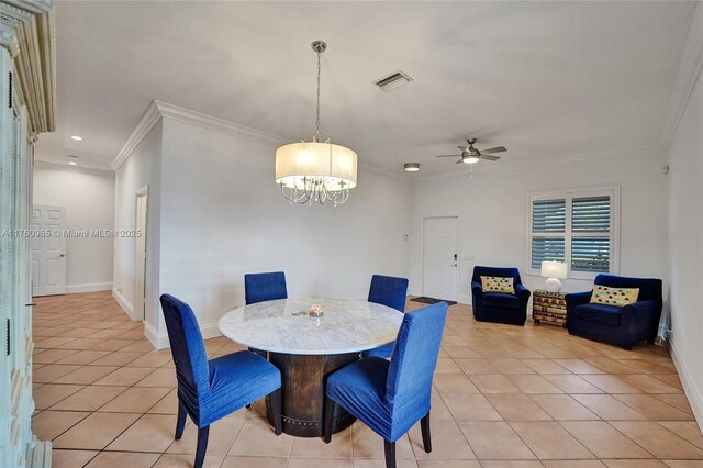 dining room featuring crown molding, visible vents, and light tile patterned floors