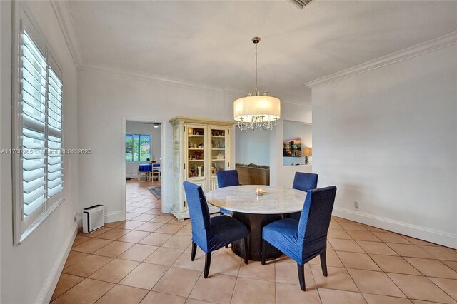 dining area featuring crown molding, ceiling fan with notable chandelier, visible vents, and light tile patterned floors