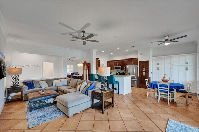 living area with light tile patterned floors, recessed lighting, ceiling fan, and crown molding