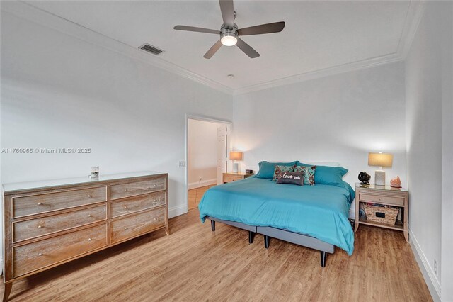 bedroom featuring baseboards, ornamental molding, and wood finished floors