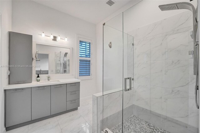 bathroom featuring marble finish floor, vanity, and a marble finish shower