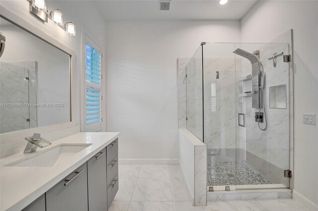 bathroom featuring vanity, marble finish floor, baseboards, and a marble finish shower