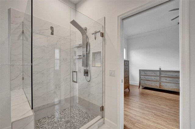 bathroom featuring marble finish floor, baseboards, ornamental molding, and a marble finish shower