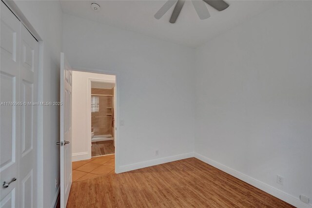 office space with wood finished floors, a ceiling fan, and baseboards