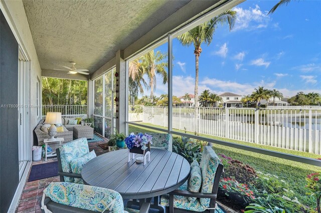 sunroom / solarium with outdoor dining area and brick floor