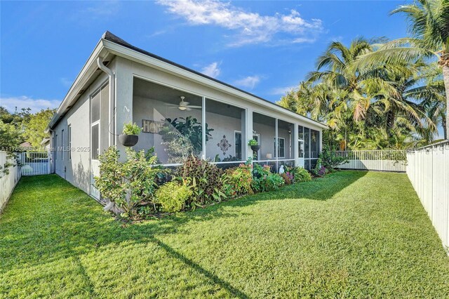 view of yard featuring a fenced backyard and a sunroom