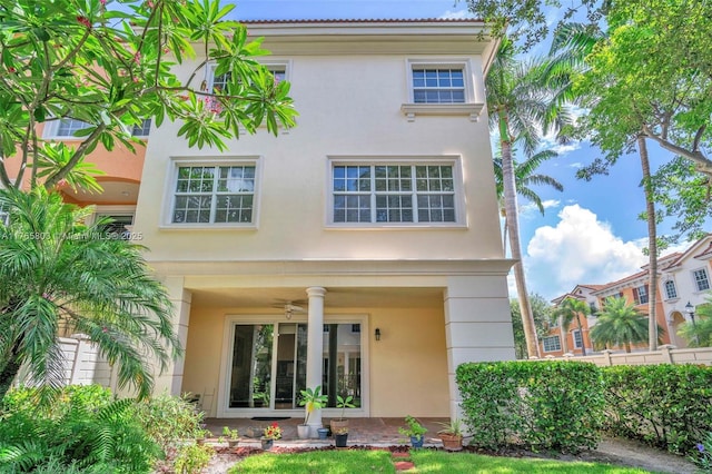 616 NE Venezia Ln Unit 616, Boca Raton, FL 33487 - rear view of property featuring stucco siding and ceiling fan