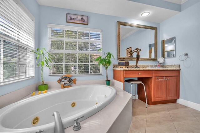 616 NE Venezia Ln Unit 616, Boca Raton, FL 33487 - bathroom with vanity, tile patterned floors, a tub with jets, and baseboards