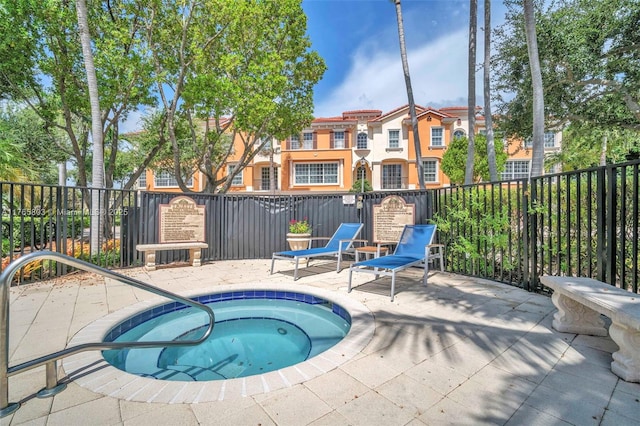 616 NE Venezia Ln Unit 616, Boca Raton, FL 33487 - view of swimming pool with a patio, a community hot tub, and fence