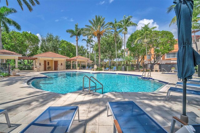 616 NE Venezia Ln Unit 616, Boca Raton, FL 33487 - community pool featuring a patio and fence