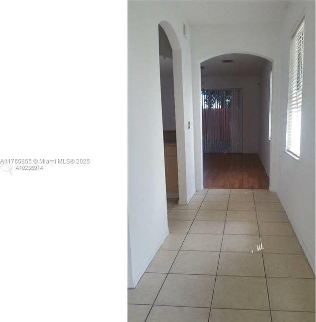 corridor with light tile patterned flooring