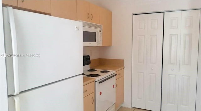 kitchen featuring white appliances and light countertops