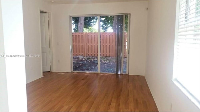 spare room with wood finished floors