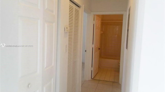 corridor featuring light tile patterned flooring